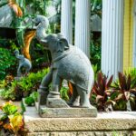 a statue of an elephant with a bird on its back